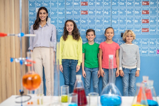 Teacher with children standing smiling at camera