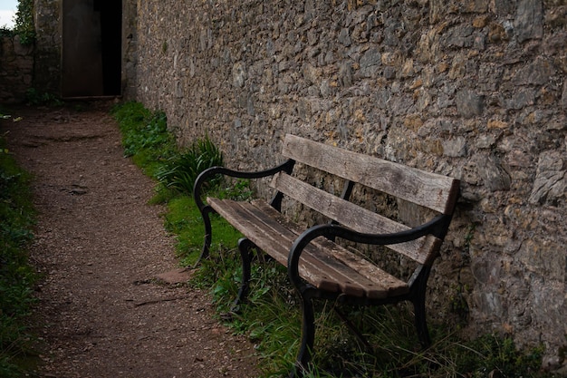 A teak hardwood wooden bench on the lawn in the UK winter