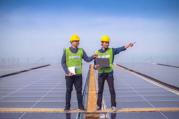 Team Asian Engineer checking solar power solar cell energy on rooftop of factoryTeam Asian worker working install solar power solar cell energy system for using clean energy