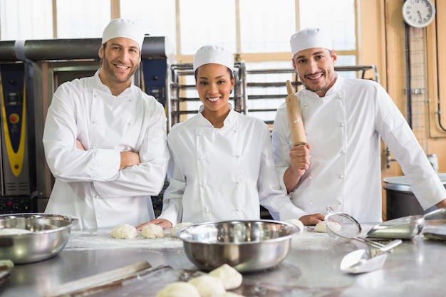 Team of bakers preparing dough