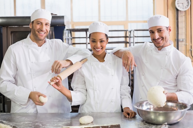 Team of bakers smiling at camera