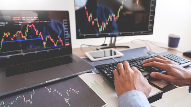 team of broker or traders talking about forex on multiple computer screens of stock market