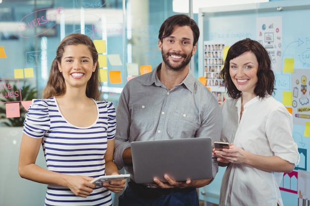 Team of business executives standing together in office