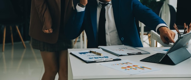 Photo team of business people working together in the meeting room office teamwork background charts and graphs banner double exposure successful teamworkbusiness planning concept