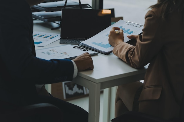 Team of business people working together in the meeting room office teamwork background charts and graphs banner double exposure successful teamworkbusiness planning concept