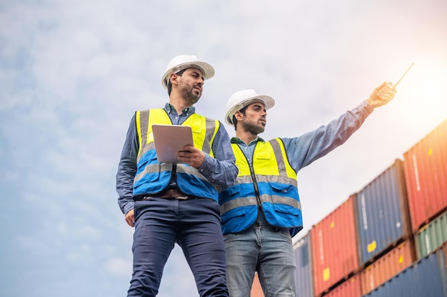 Team Businessman working on site containers yard for business shipping import and export Caucasian worker inspecting container in warehouse logistic delivery services export management team