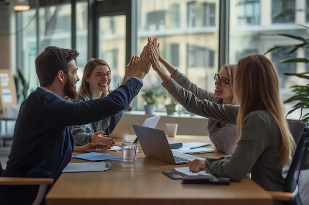 A team of colleagues highfiving each other after c