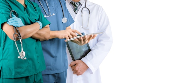 Team of doctors and nurse in hospital on white wall