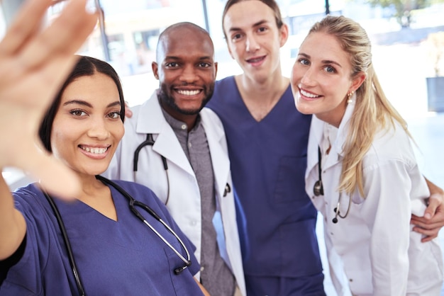 Team of doctors take a selfie together after success in the surgery emergency room in a hospital office Happy teamwork and young healthcare workers ready to help people with medical treatment