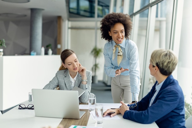 Team of female entrepreneurs communicating while having business meeting in the office