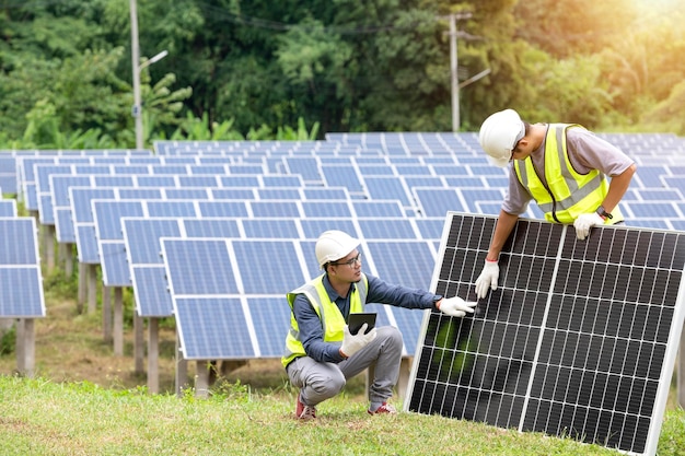 A team of male engineers is about to install solar panels at the solar power station Engineer team ordered and installed solar cells