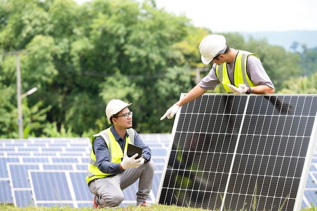 A team of male engineers is about to install solar panels at the solar power station Engineer team ordered and installed solar cells