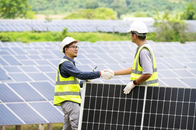 A team of male engineers is about to install solar panels at the solar power station Engineer team ordered and installed solar cells