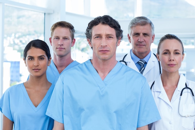 Team of serious doctors looking at camera