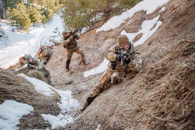 Team of special forces weapons in cold forest Winter warfare and military concept