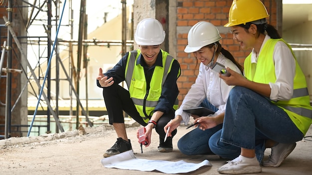 Team of specialists and Civil engineer inspecting industrial building construction site