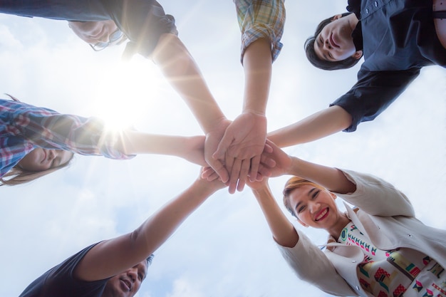 Team work concept. Business people joining hands. business people making pile of hands