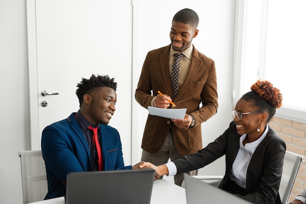 team of young african people in the office at the table with a laptop