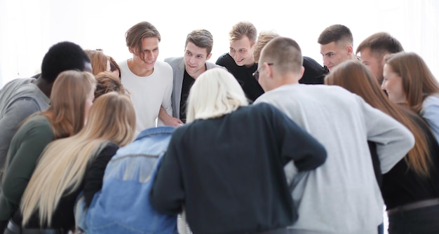 Team of young people standing in a circle