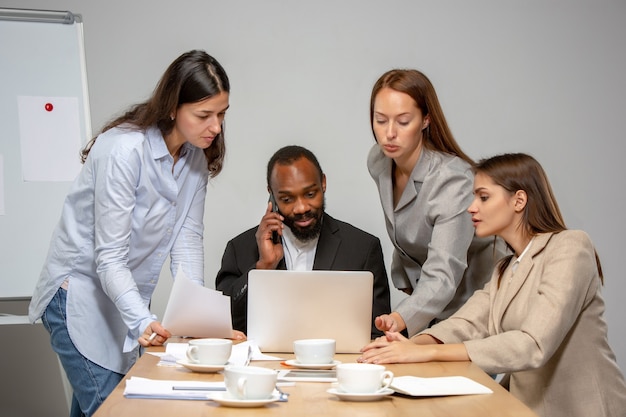 Team. Young people talking, working in videoconference with colleagues, co-workers at office or living room. Online business, education during insulation, quarantine. Work, finance, tech concept.