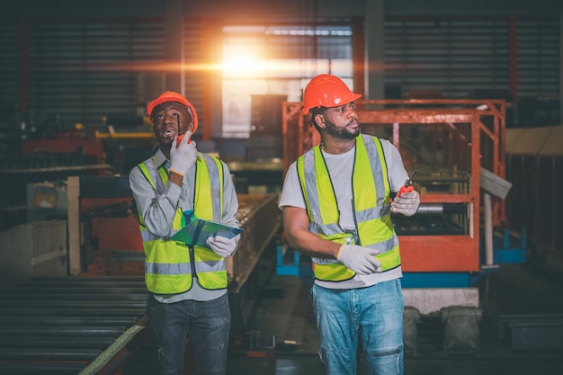 Teamwork African American black man are worker and working in metal heavy factory