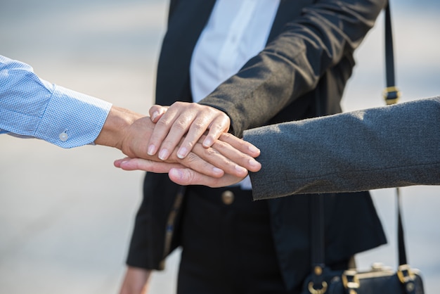 Teamwork of business people, stacking hands together.