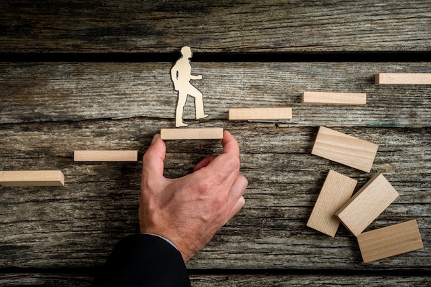 Teamwork concept with businessman holding up stairs