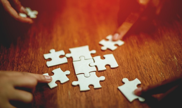 Teamwork unity and cooperation concept hand holding jigsaw closeup piece of hand that connect puzzle connected to each other business solution Success Concepts and Strategies