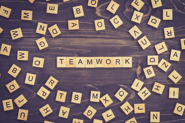 Teamwork word wood block on table for business concept.