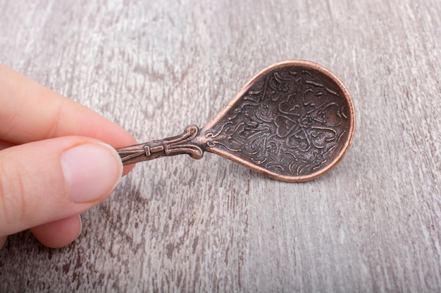 Teaspoon made of metal in hand