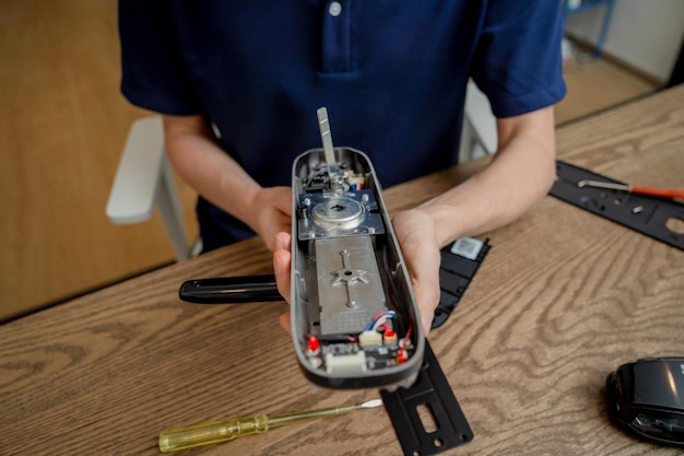 A technician assembles and installs smart electronic door lock for house protection