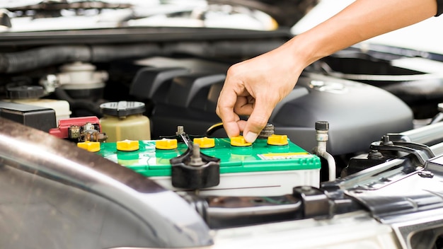 technician checking car battery.