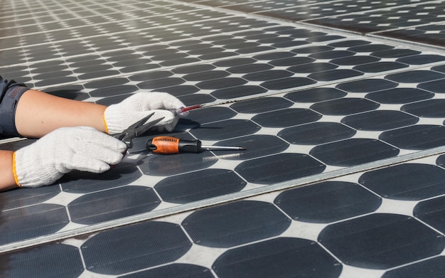 Technician checking and clean old solar panels