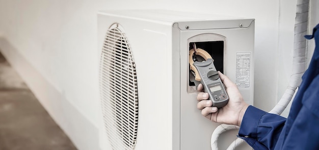 Technician checking the operation of the air conditioner