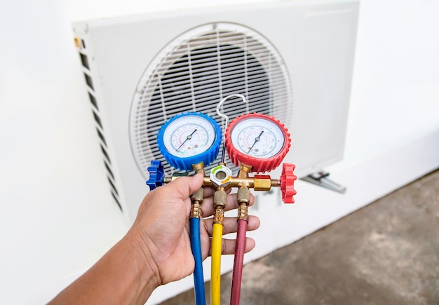 Technician checking the operation of the air conditioner.