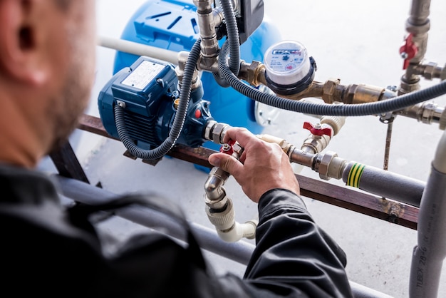 Technician checking water system nodes.