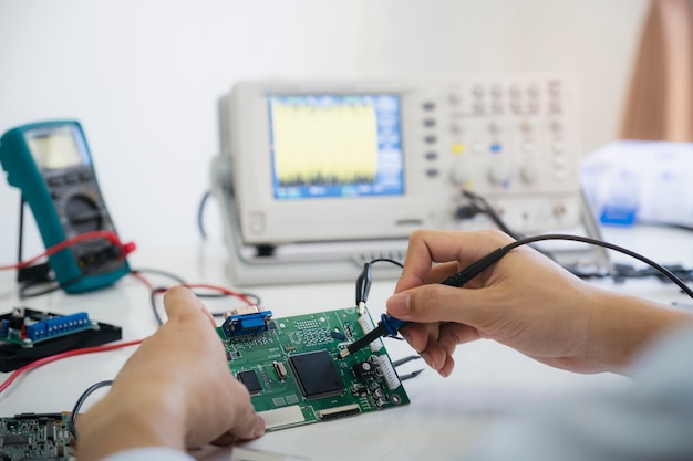 Technician checks the electronic device.