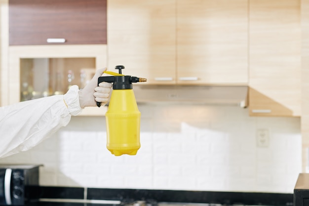 Technician holding bottle of detergent