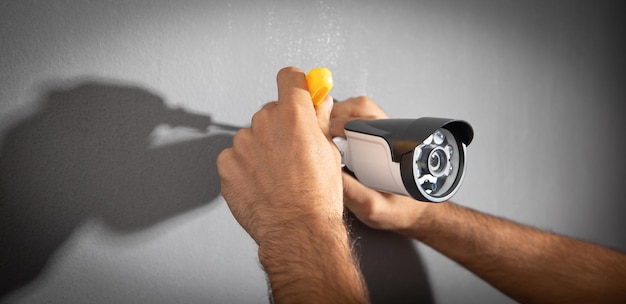 Technician installing CCTV camera system for home