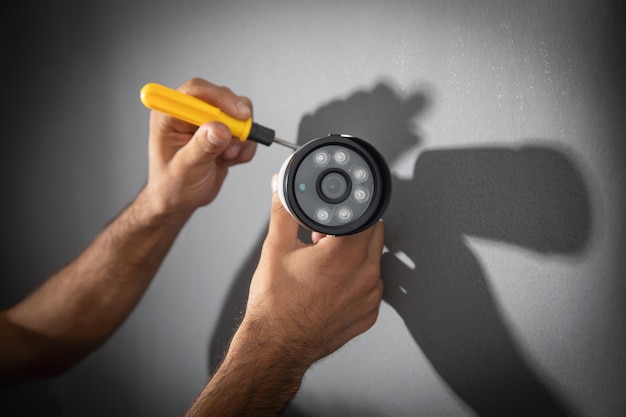 Technician installing CCTV camera system for home