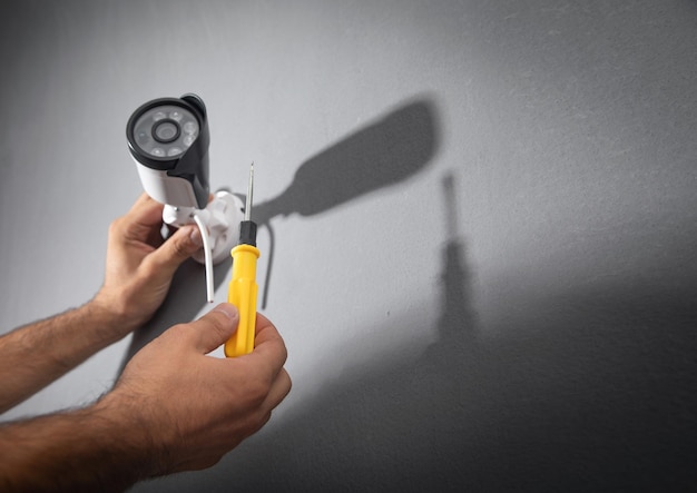 Technician installing CCTV camera system for home