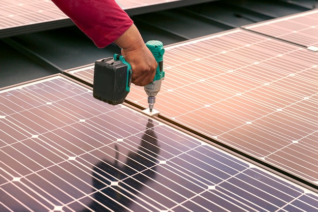 Technician installing solar panels by screwdriver Renewable energy clean and good environment