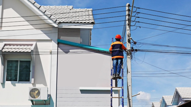 technician internet service provider is checking fiber optic cables after install on electric pole