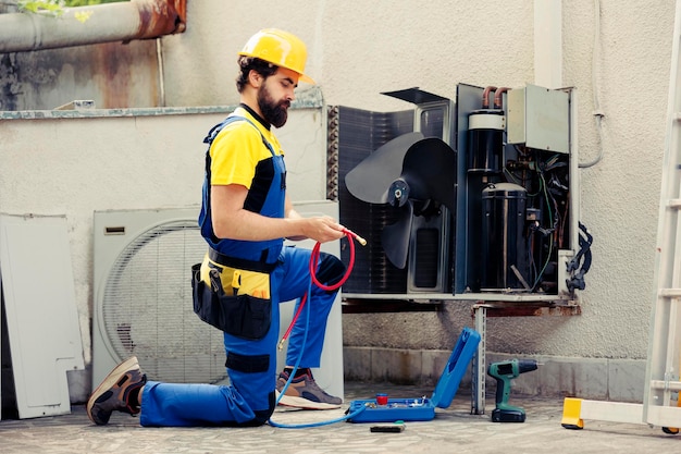 Technician maintenancing air conditioner