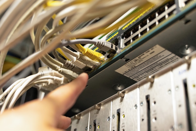 Technician pointing at cables in cables room