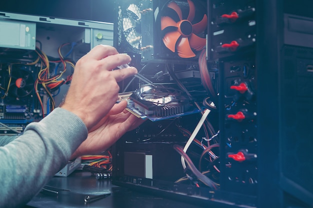 Technician repairing a computer, the process of replacing components on the motherboard