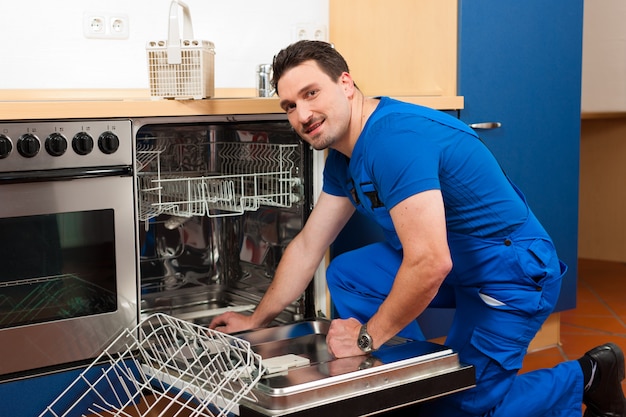 Technician repairing the dishwasher