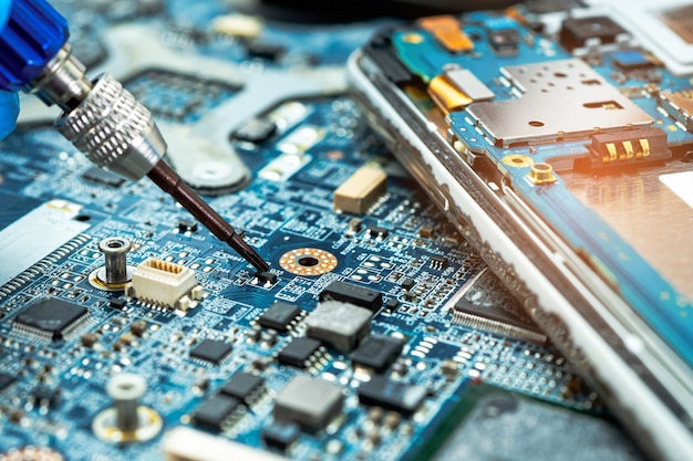 Technician repairing inside of hard disk by soldering iron. Integrated Circuit. the concept of data, hardware, technician and technology.