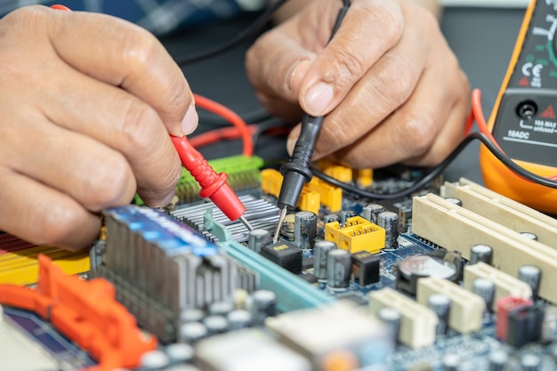 Technician repairing inside of mobile phone by soldering iron Integrated Circuit the concept of data hardware technology