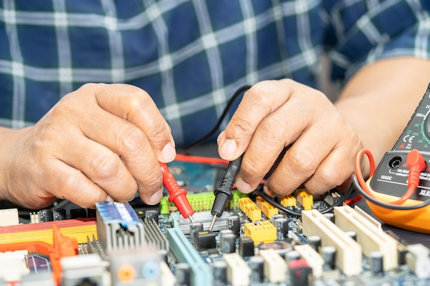 Technician repairing inside of mobile phone by soldering iron Integrated Circuit the concept of data hardware technology